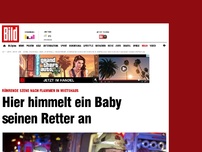 Bild zum Artikel: Nach Brand in Mietshaus - Hier himmelt ein Baby seinen Retter an