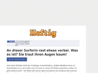 Bild zum Artikel: An dieser Surferin rast etwas vorbei. Was es ist? Sie traut ihren Augen kaum!