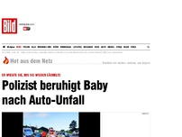 Bild zum Artikel: Erste Hilfe nach Unfall - Polizist wiegt ein Baby, bis es lächelt