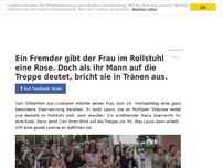 Bild zum Artikel: Ein Fremder gibt der Frau im Rollstuhl eine Rose. Doch als ihr Mann auf die Treppe deutet, bricht sie in Tränen aus.