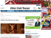 Bild zum Artikel: Protest im Kölner Dom - Nackte Frau klettert auf Altar