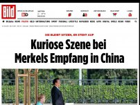 Bild zum Artikel: Sie bleibt sitzen, er steht auf - Kuriose Szene bei Merkels Empfang in China